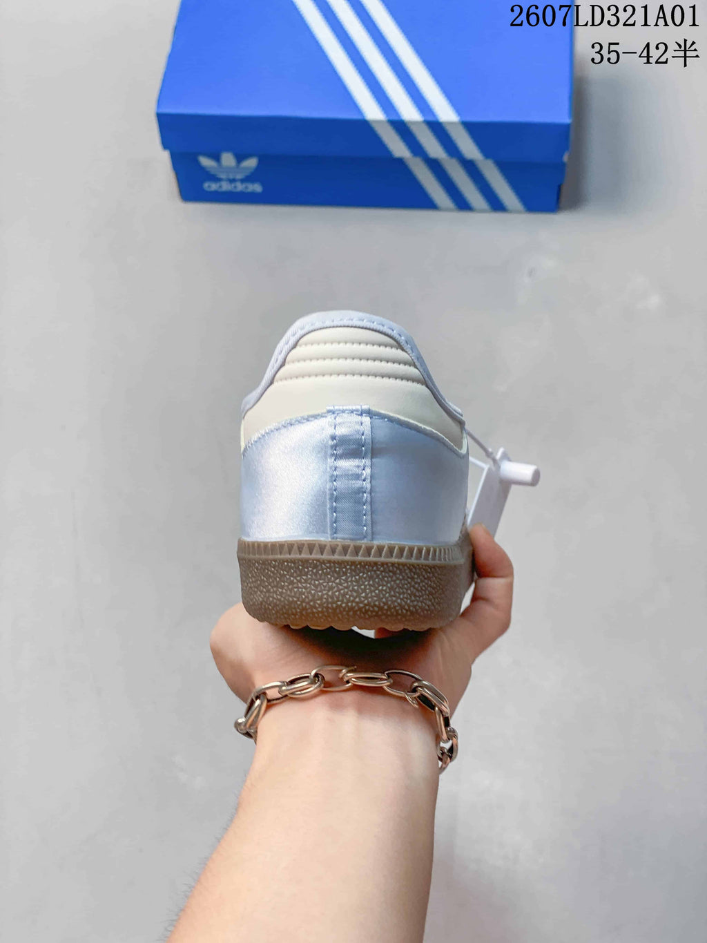 Rear view of a pale blue Samba Jane sneaker with a gum-colored heel sole.