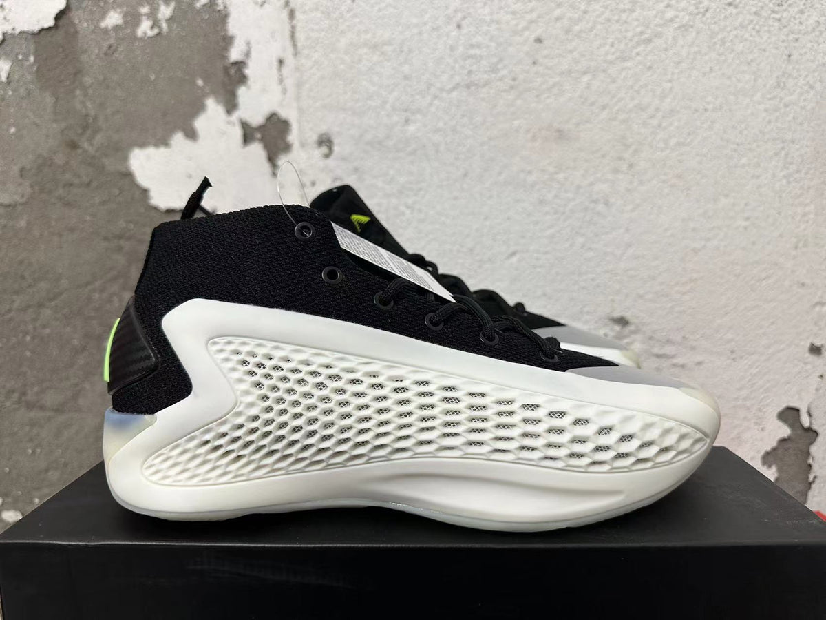 Side view showing the black upper, white textured side panel, and sculpted sole.