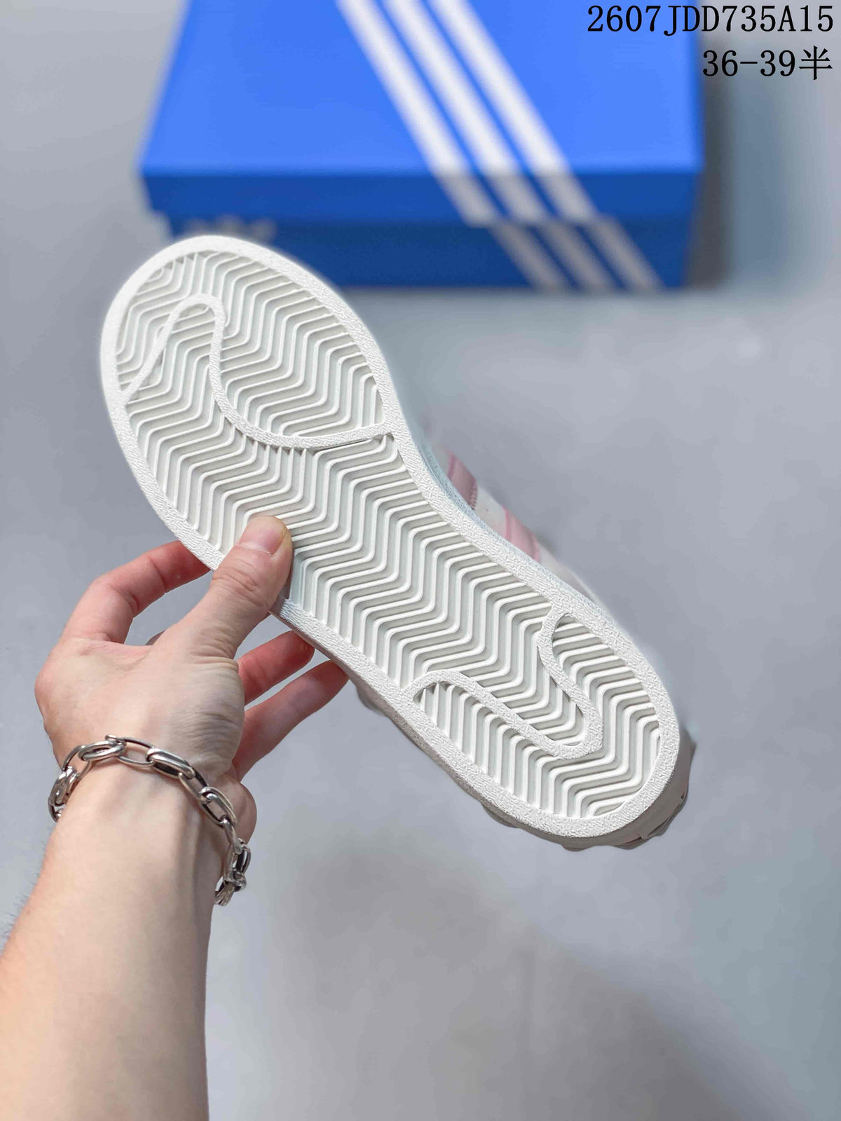 Close view of the white outsole showing its zigzag tread pattern.