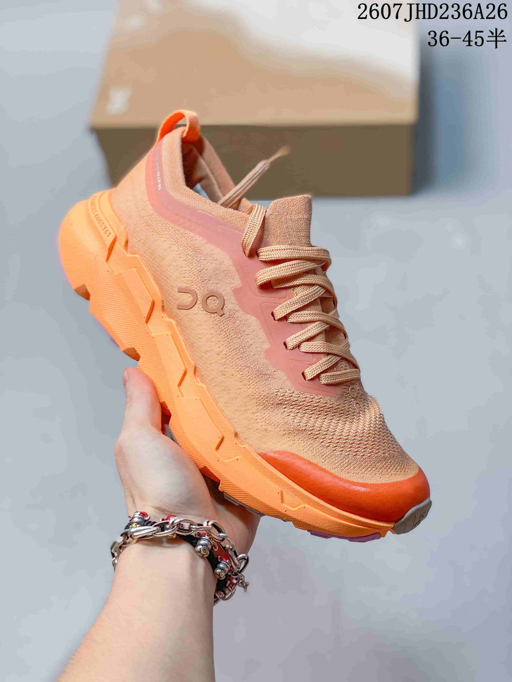 Three-quarter side view of the peach-orange trail running shoe with layered sole construction.