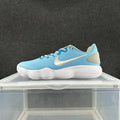 Blue low-top Nike sneakers with a white side mark and ribbed white sole, photographed from the side.