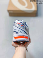 Rear view of the white ASICS sneaker showing the layered heel construction and orange heel accent.