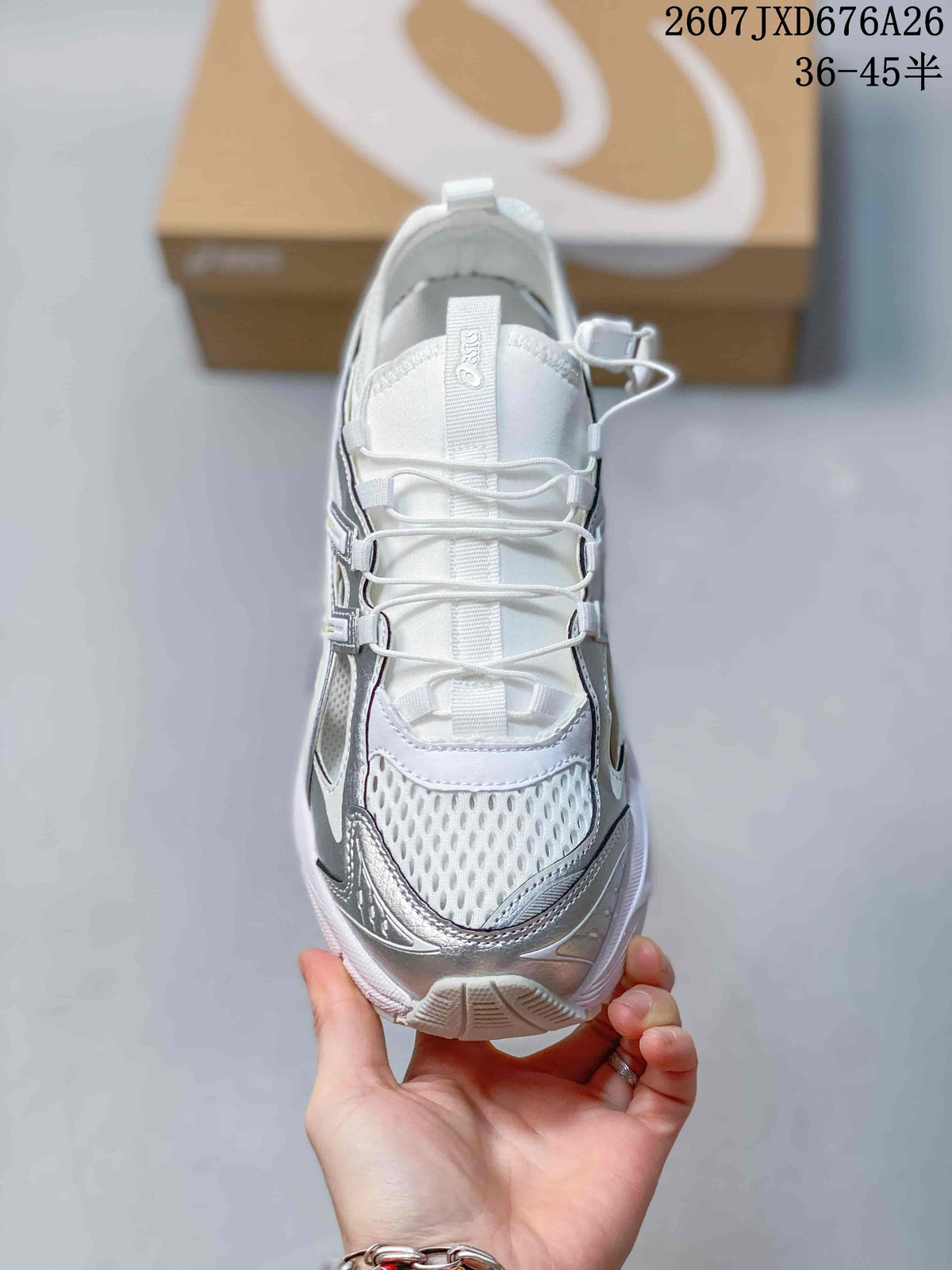 Top view of the sneaker showing the mesh-look toe panel, lace system, tongue pull tab, and contrasting silver overlays.