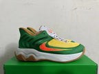 Side view of a green and yellow Nike basketball shoe with an orange Swoosh and gum outsole.