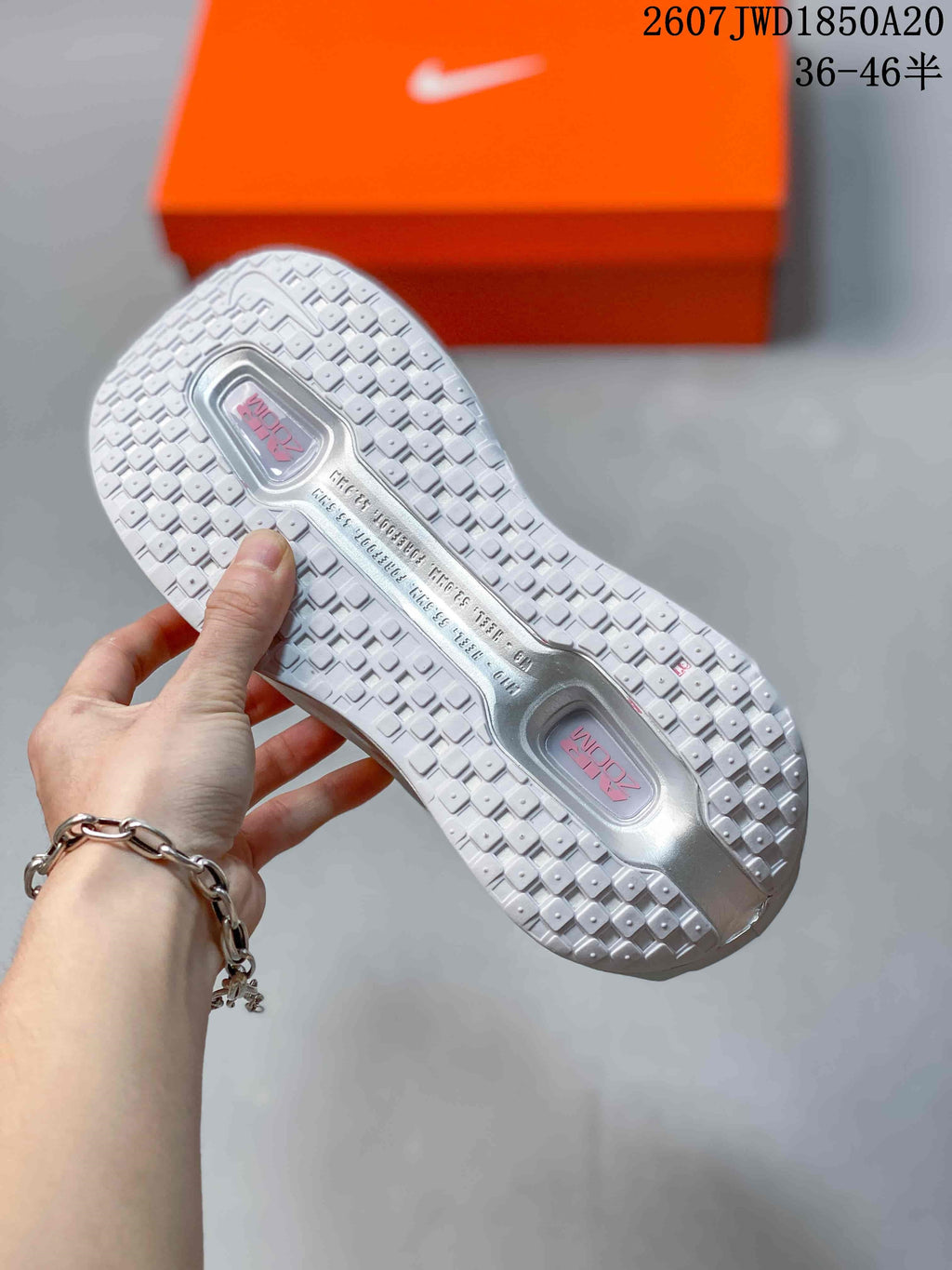 White textured outsole of the sneaker showing rectangular tread blocks and two visible cushioning windows.