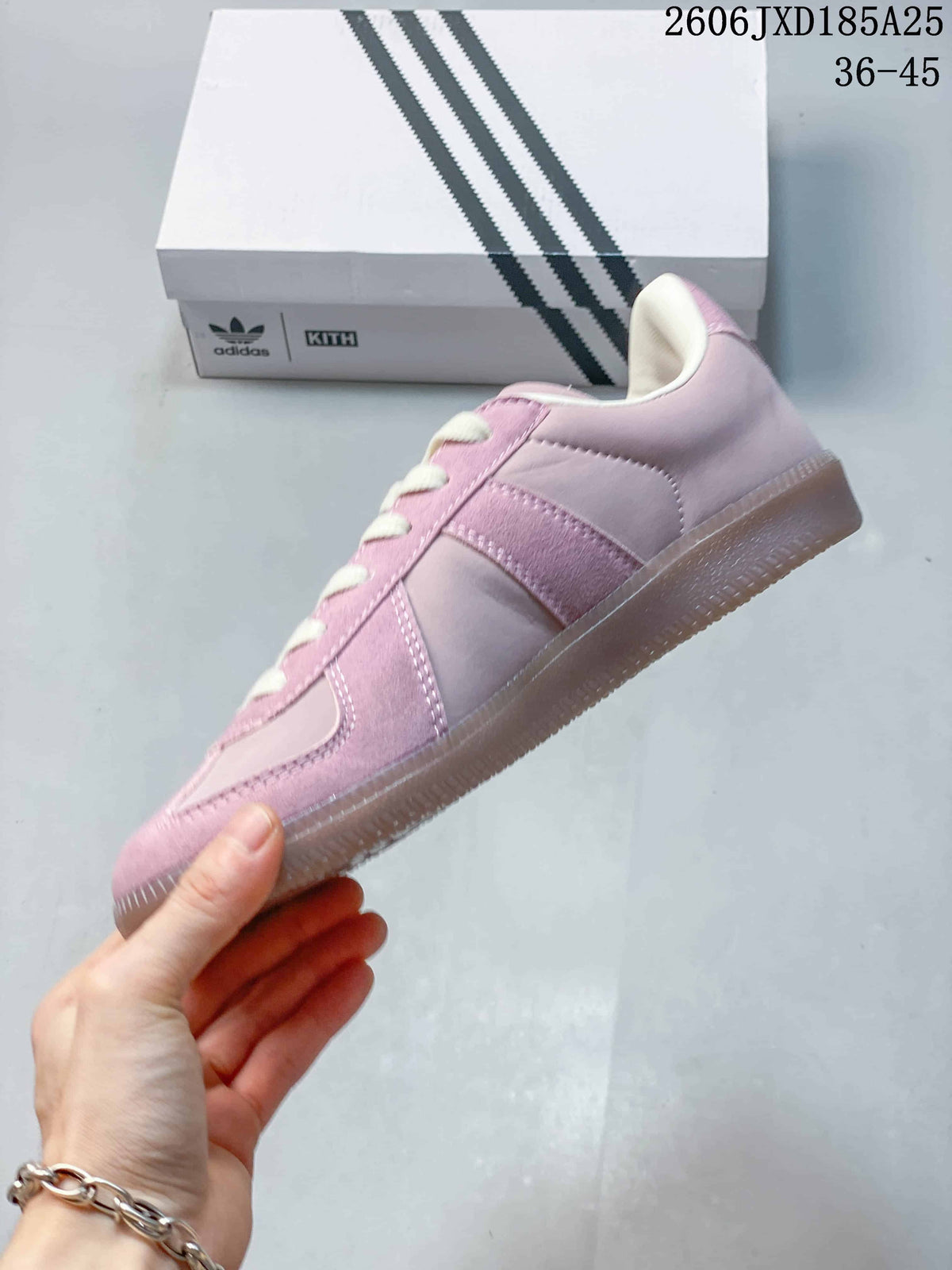 Side view of the pink low-top sneaker with layered panels and gum-colored sole.