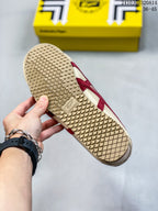 Bottom view of the sneaker showing the patterned rubber outsole and branded sole detail.