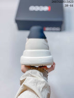 Rear view of the light gray sneaker showing the padded heel collar and raised white outsole.