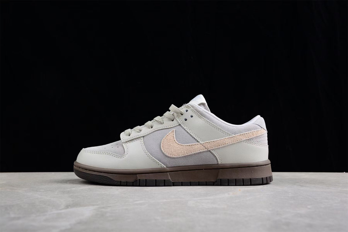 Opposite side view showing the beige Swoosh, layered panels and dark brown sole.