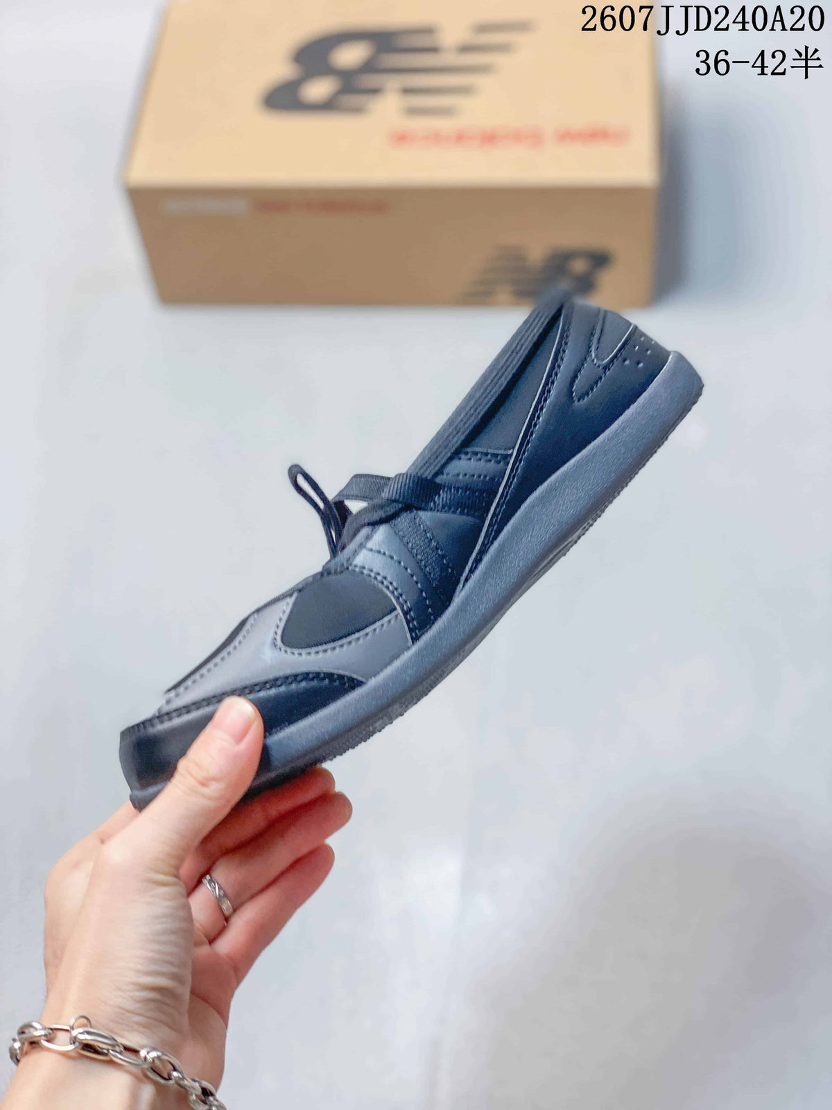Side view showing the black and gray upper, lace-up front, layered overlays, and low-profile sole.