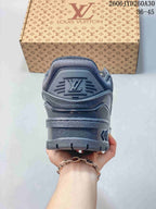 Rear view of the charcoal sneaker with a raised logo on the heel