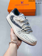Hand-held side view of a white low-top sneaker with patterned toe and heel sections.