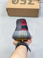 Rear view of the sneaker showing the red and gray knit-style upper, black heel band, and ribbed gray heel outsole.