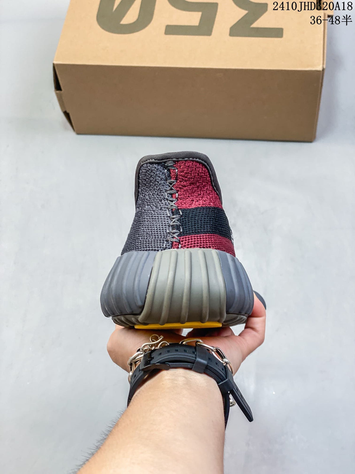 Rear view of the sneaker showing the red and gray knit-style upper, black heel band, and ribbed gray heel outsole.