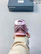 Rear view of the pink sneaker showing the heel construction, layered side panels, and textured outsole.