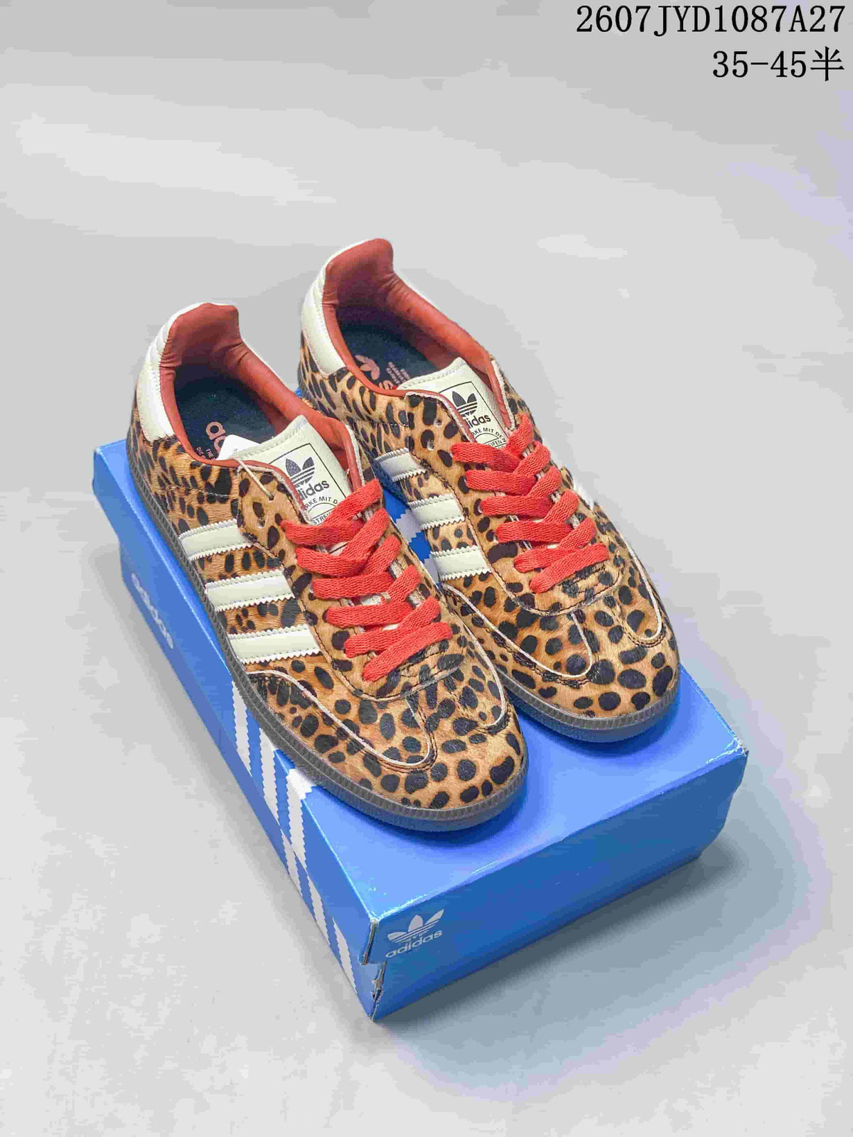 Pair of leopard-print adidas Samba ADV sneakers with red laces displayed on a blue adidas shoe box; size range text is visible at the top.