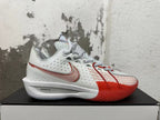 Side view of a white Nike sneaker with red details and visible ZoomX midsole text