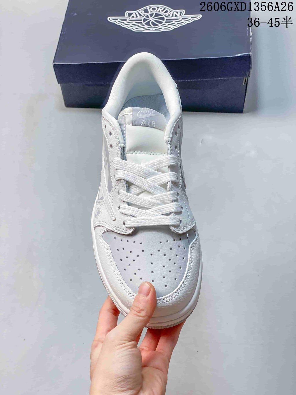 Top view showing the laces and perforated toe of a white and grey sneaker