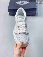 Top view showing the laces and perforated toe of a white and grey sneaker