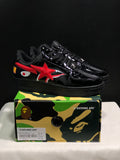 Pair of glossy black Bape Sta sneakers displayed on a camouflage BAPE shoebox; the box label shows EU 41, US 8, UK 7, and CM 26.