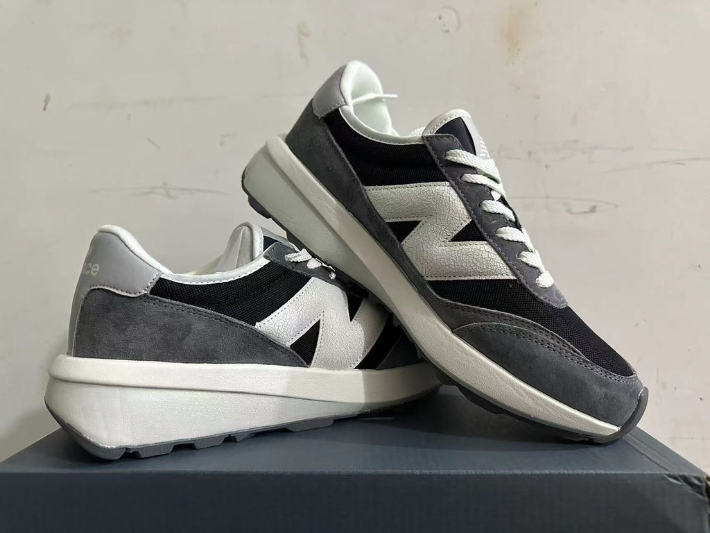 Angled view of the New Balance U370 sneakers showing the side logo and chunky midsole