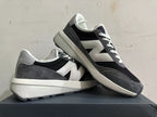 Angled view of the New Balance U370 sneakers showing the side logo and chunky midsole