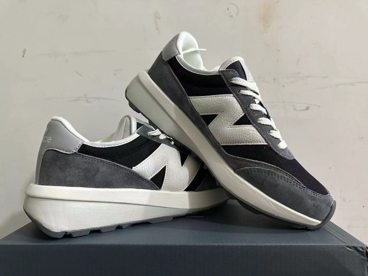Angled view of the New Balance U370 sneakers showing the side logo and chunky midsole