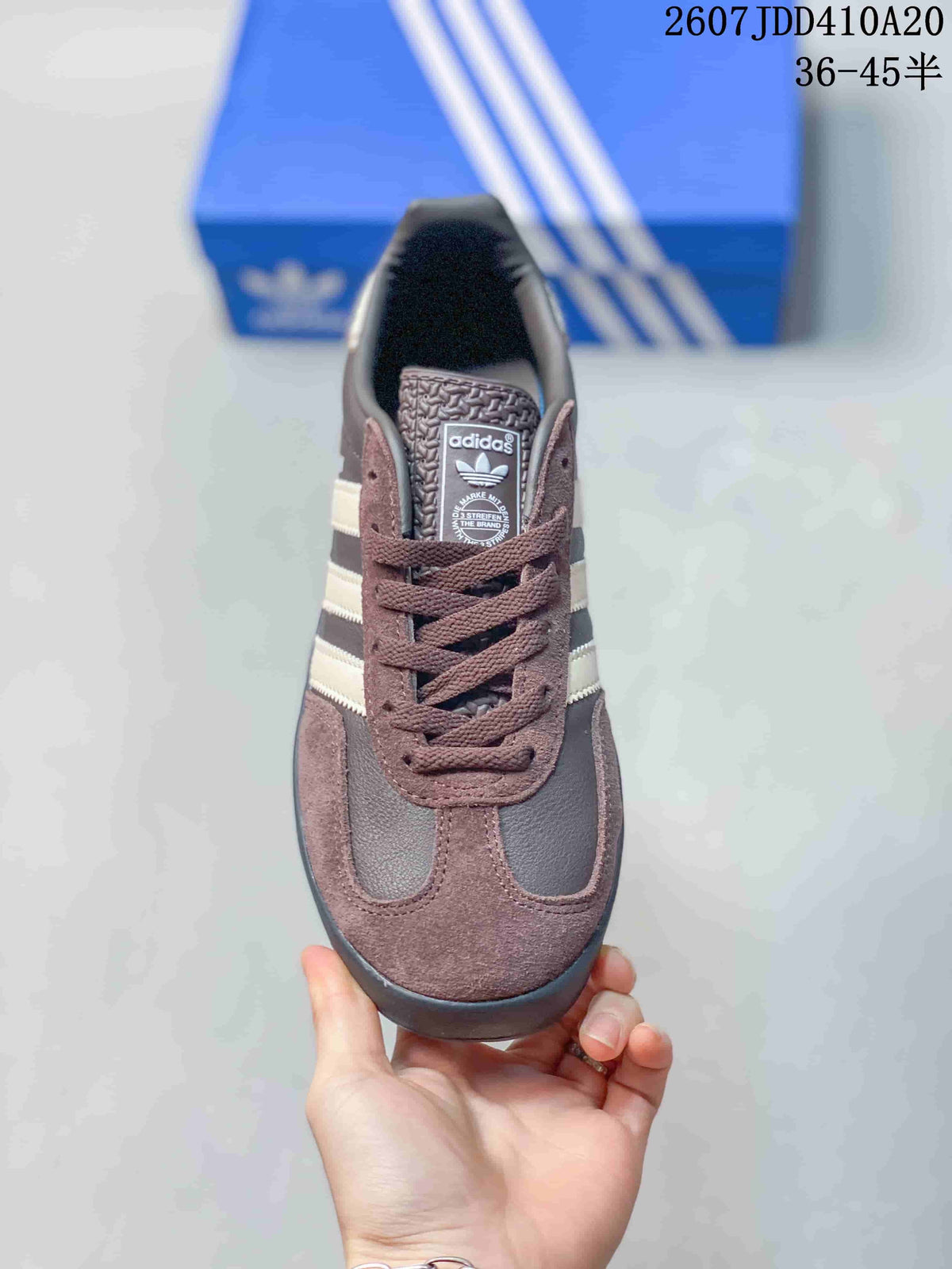 Top view showing the brown laces, branded tongue, contrasting panels, and rounded toe.