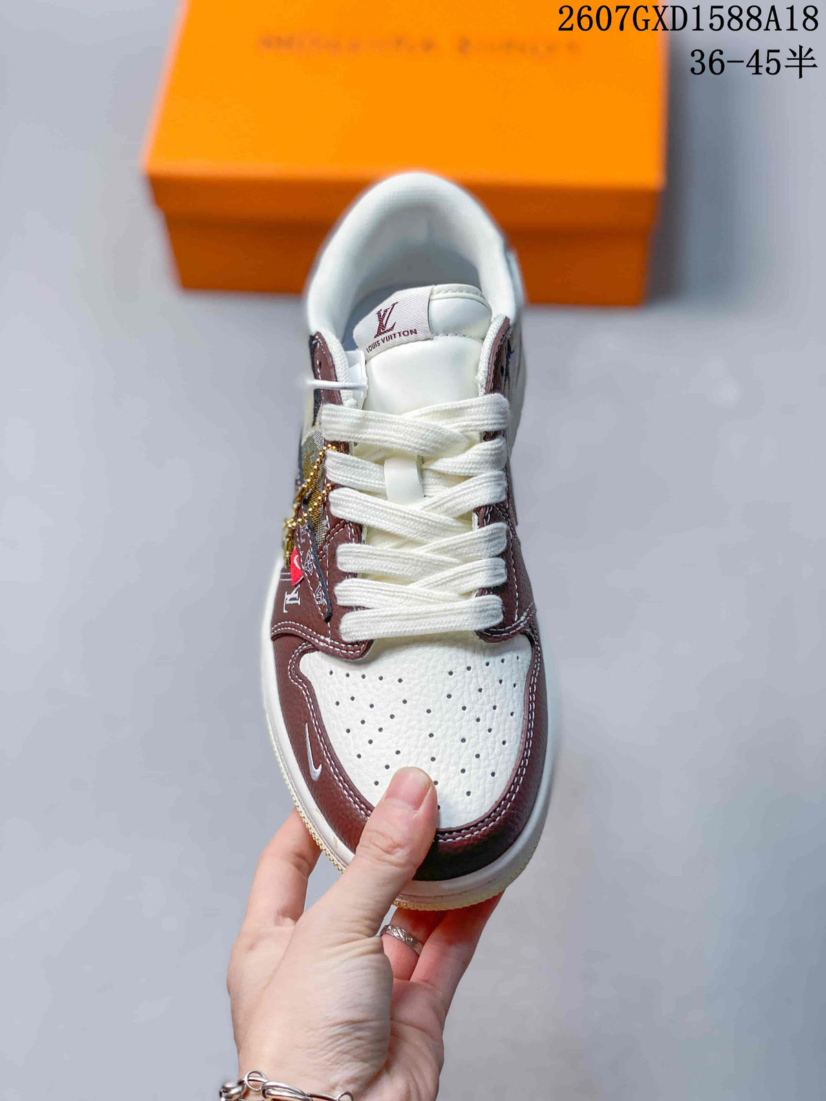 Top view of the sneaker showing white laces, a perforated light-colored toe box, and brown surrounding overlays.