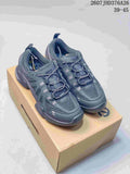 Pair of dark gray ECCO sneakers displayed on a shoe box, with mesh uppers and layered overlays visible.