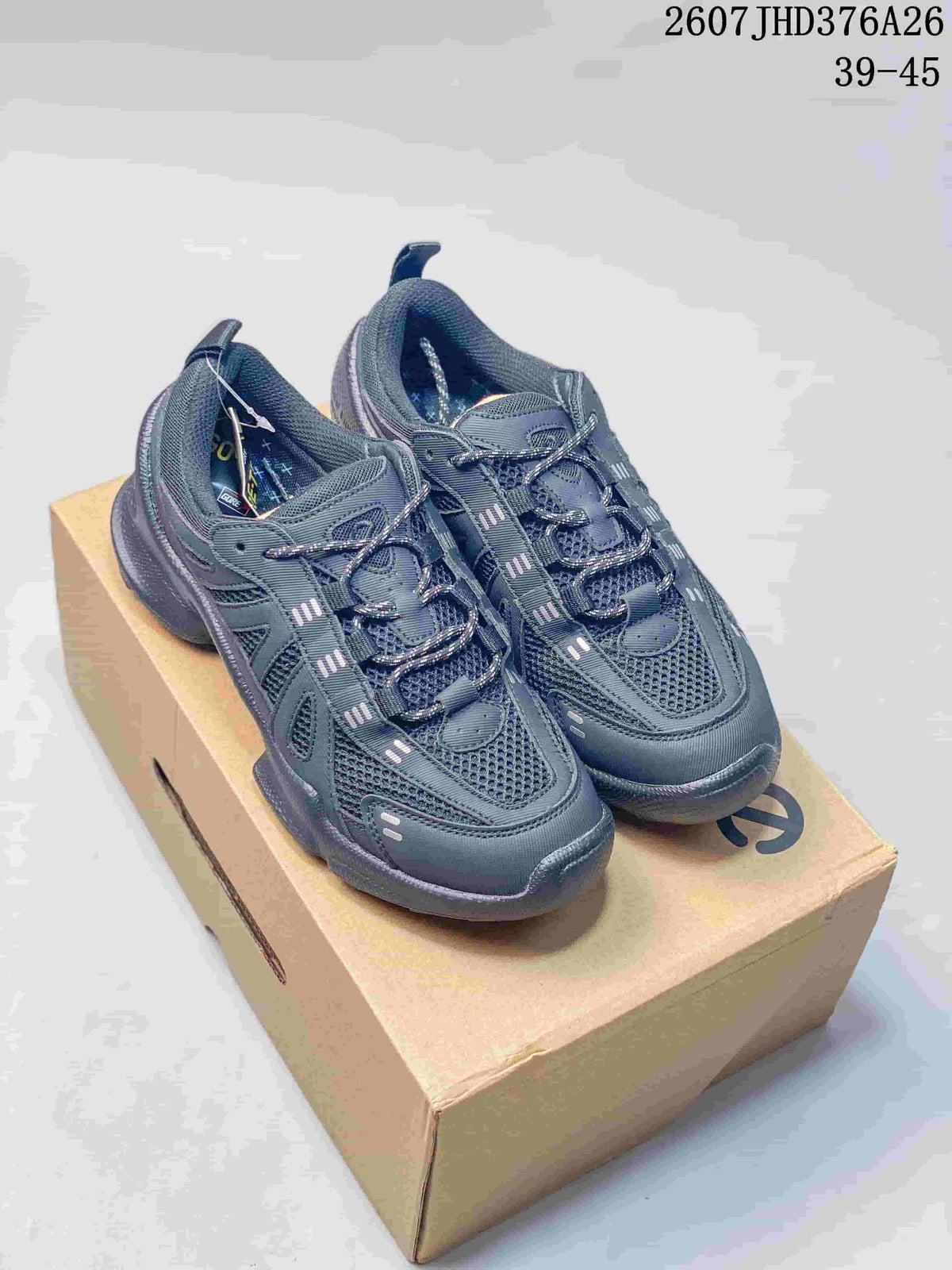 Pair of dark gray ECCO sneakers displayed on a shoe box, with mesh uppers and layered overlays visible.