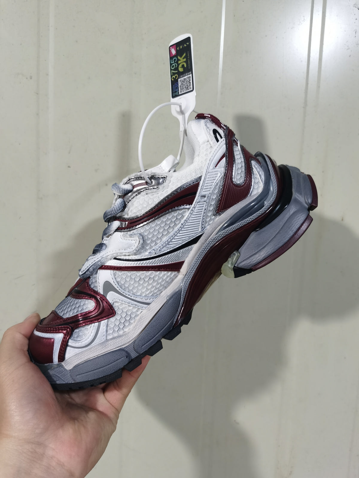 Side view of grey and wine-red Puma Runner 2 sneakers with layered panels and a chunky outsole.