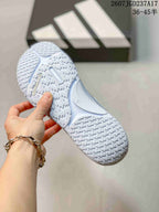 Bottom view of the crystal blue sneaker showing the textured outsole pattern and adidas branding.
