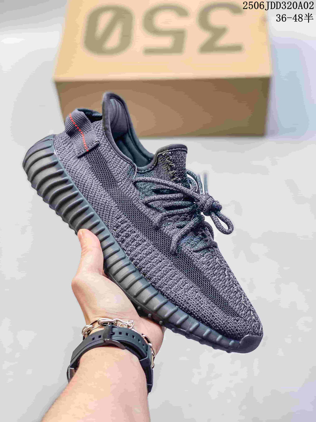 Dark gray Adidas Yeezy-style sneaker with a tonal textured upper and ridged sole.