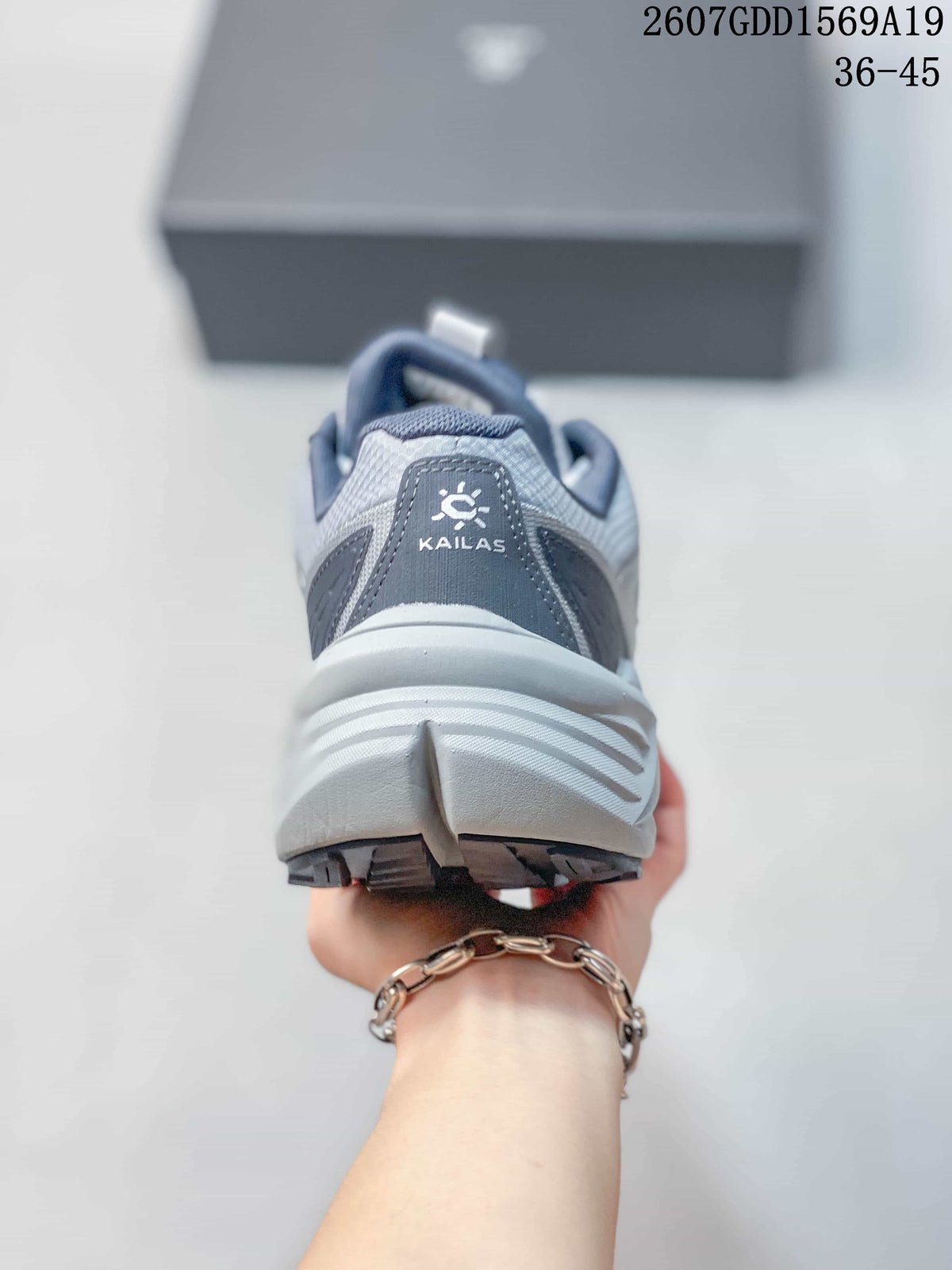 Rear view of the gray KAILAS shoe showing the padded heel collar, heel branding, and layered midsole.