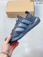 Side view of the dark gray sneaker showing the mesh upper, layered perforated side panels, lace system, and rugged sole.