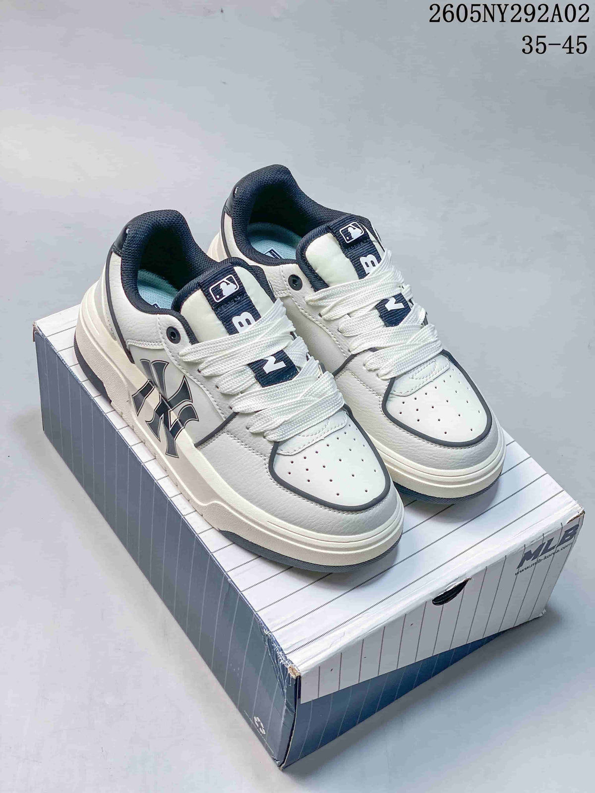 Pair of white MLB Chunky Liner sneakers with navy accents