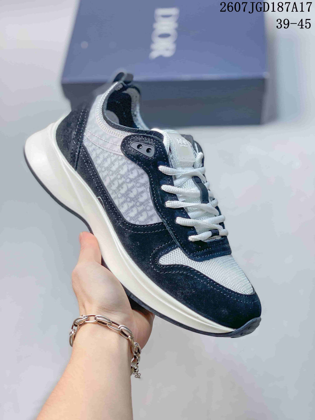 Black and white Dior B25 Runner sneaker with textured side panels and a light outsole.