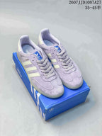 Pair of lavender and cream adidas Samba ADV sneakers displayed on a blue shoebox, with style code and size-range text visible above.