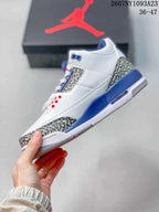 Side view showing the white high-top upper, elephant-print toe and heel panels, blue midsole accents, and visible air window.