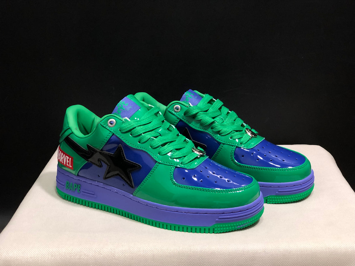 Three-quarter front view of the matching pair with green laces, blue toe panels and purple midsoles.