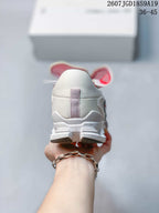 Rear view of the white sneaker showing the heel structure and outsole detail.