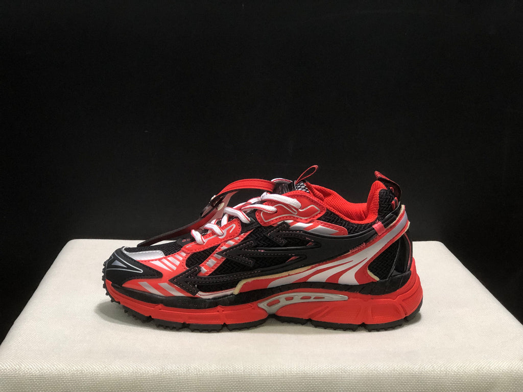 Outer side profile showing the layered upper, mesh paneling, padded collar, and chunky red sole.