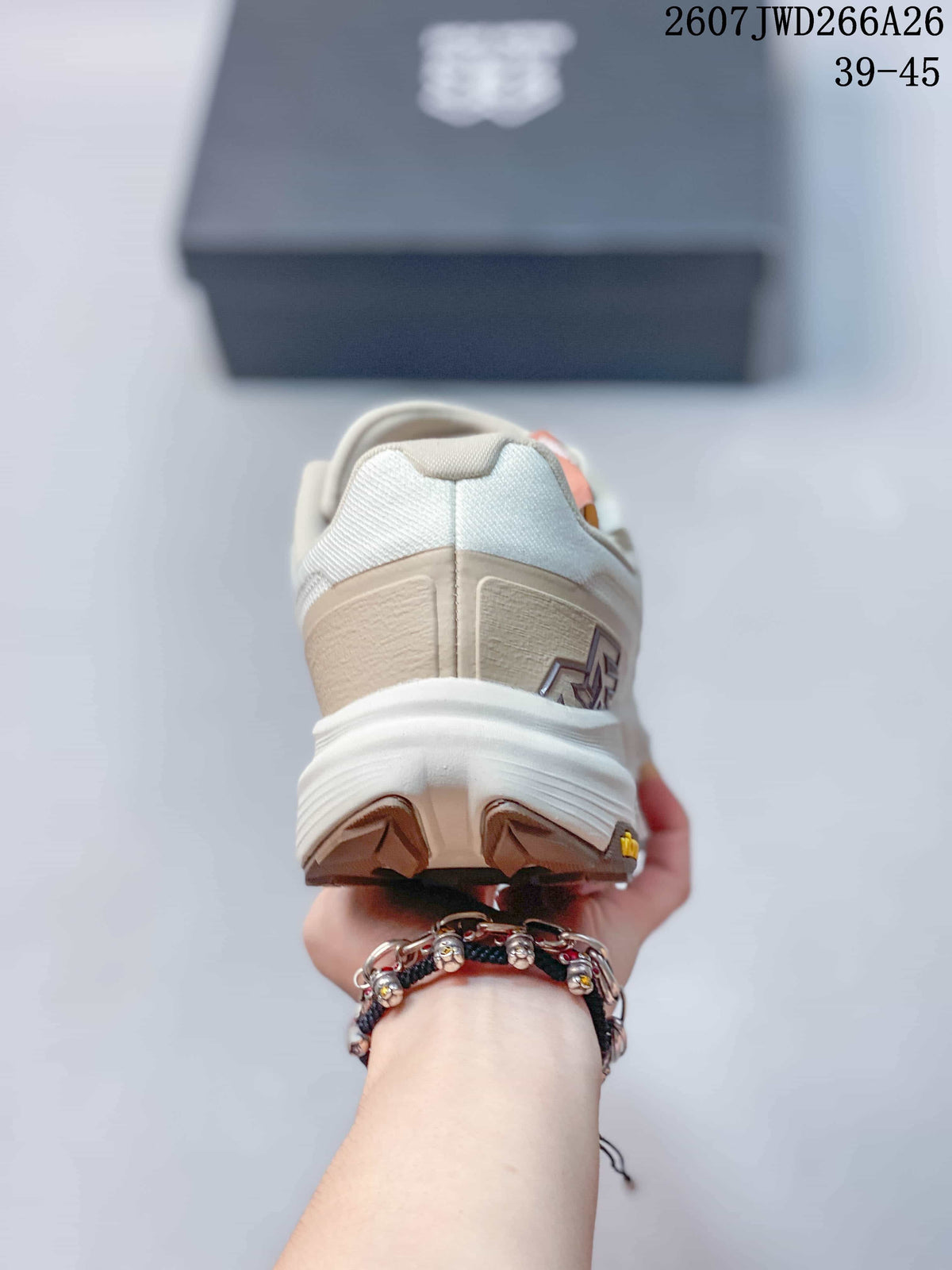 Rear view of the cream and white trail running shoe showing the layered heel and lugged outsole.