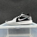 Side view of a low-cut Nike Sabrina basketball shoe in grey, silver, black, and white.