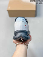 Rear view showing the white heel, On branding, dark collar, and red side detail.