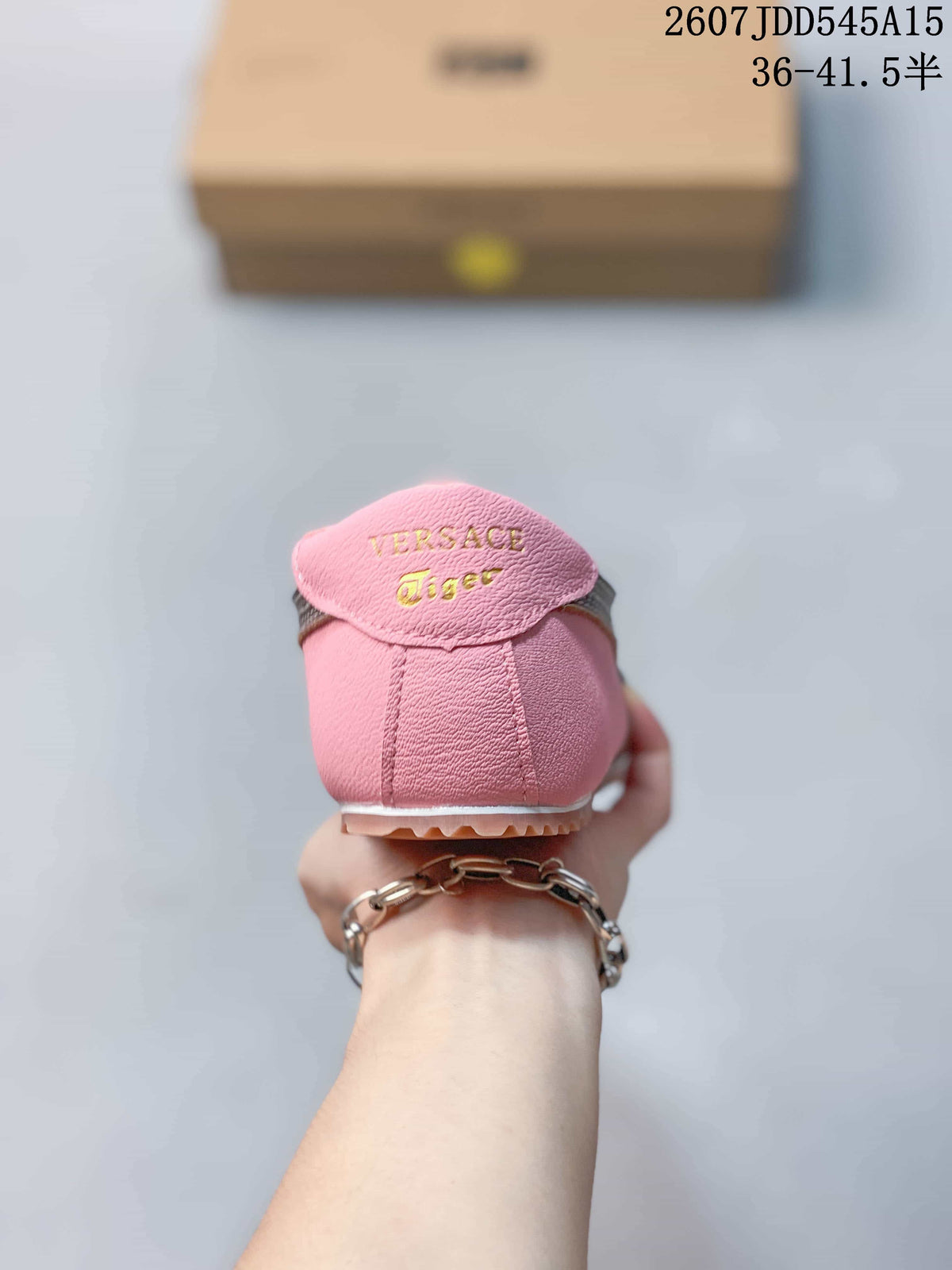 Rear view of the pink sneaker showing the branded heel tab and textured outsole.