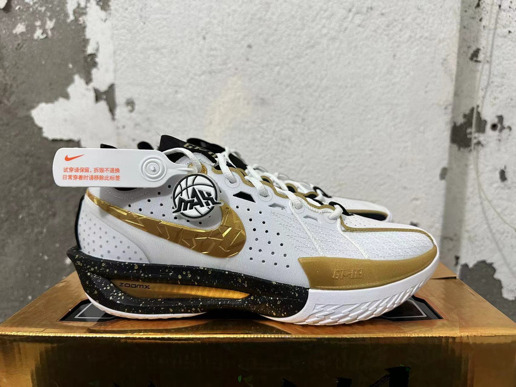 Side view showing the gold Swoosh and speckled black midsole