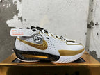 Side view showing the gold Swoosh and speckled black midsole