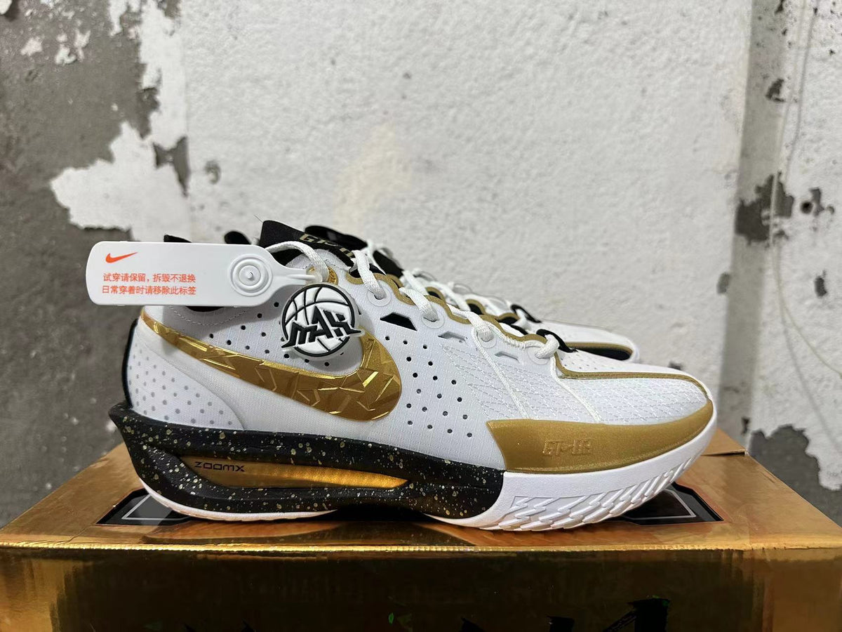 Side view showing the gold Swoosh and speckled black midsole